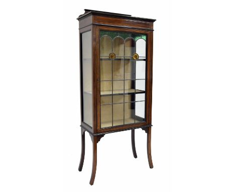 Edwardian mahogany inlaid display cabinet, with a single leaded stained glass door enclosing fixed shelves and upon slender s