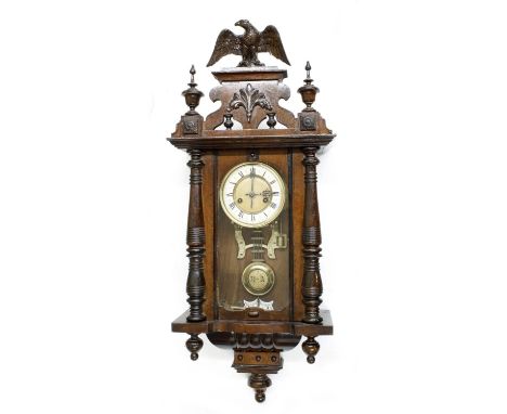 Vienna two-train wall clock, with eagle finial pediment over pillared case, 34" high (pendulum and winding key) 