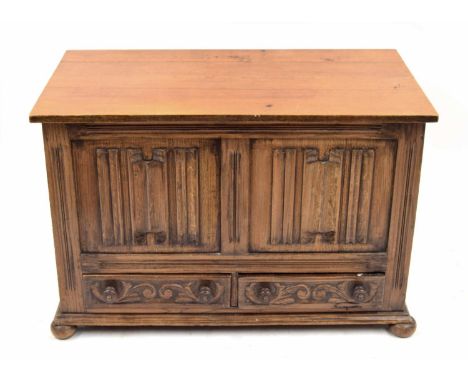 18th century style small oak coffer, the hinged top over a carved linen fold panelled front and two short drawers, supported 