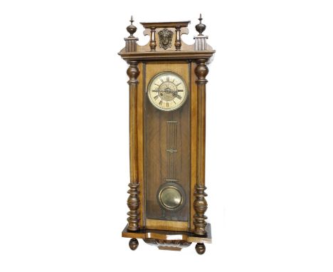 Vienna two-train walnut wall clock, with mask pediment over column case, 41" high (pendulum and winding key) 