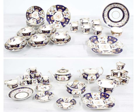 Attractive early 19th century English porcelain tea service painted with flowers within blue and gilt highlighted borders com