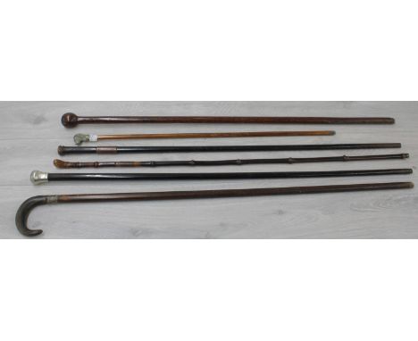 Six vintage walking sticks, including a horn handled crook stick and one applied with a silvered dog's head (6) 