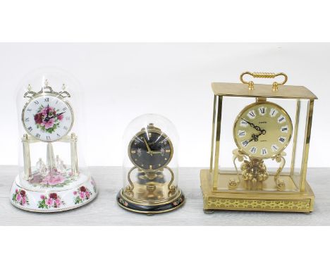Kundo quartz torsion style brass clock, 9.5" high; together with a Schatz torsion style clock and a modern porcelain clock be