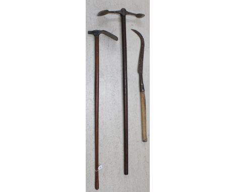 Two old wooden handled trenching tools, longest 55"; together with a scythe type implement (3) 