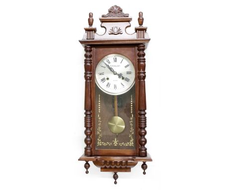 Vienna type 31 day two-train wall clock, the dial signed Lauraln, with shaped pediment and pillared case, 31" high (pendulum 