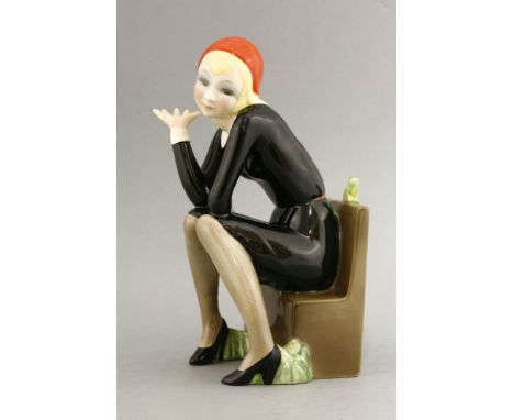 A Lenci figure,'Nella', modelled by Helen Koenig Scavini, modelled as a girl seated on a bench beside an open book, a frog se