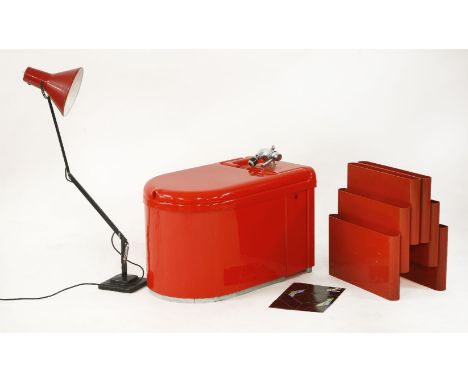 A Teuco red bidet,1970s, part of the Aquarius range, with original leaflet,a Kartell magazine rack,designed by Giotto Stoppin