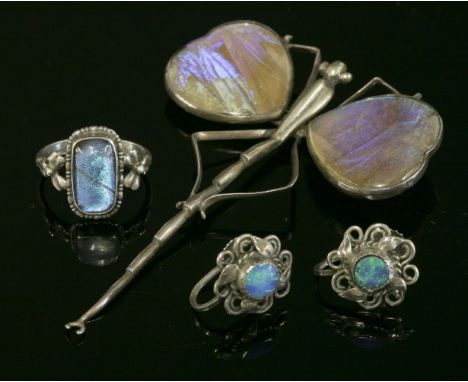 A pair of Arts and Crafts black opal doublet earrings,each one with a circular black opal doublet set to the centre, a twiste