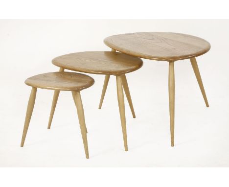An Ercol nest of three 'Pebble' tables,one labelled, 65cm wide45cm high (3)