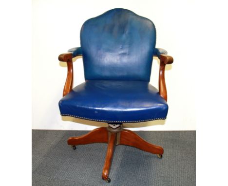 An upholstered vintage swivel desk chair.