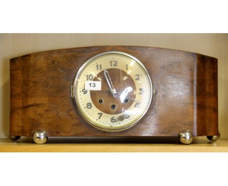 An Art Deco walnut veneered mantle clock, W. 51cm.