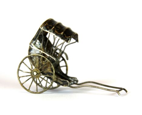 A small Chinese hallmarked silver model of a rickshaw, H. 4.5cm.