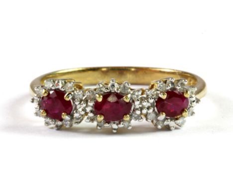 A 9ct yellow gold ruby and diamond set triple cluster ring, (O.5).