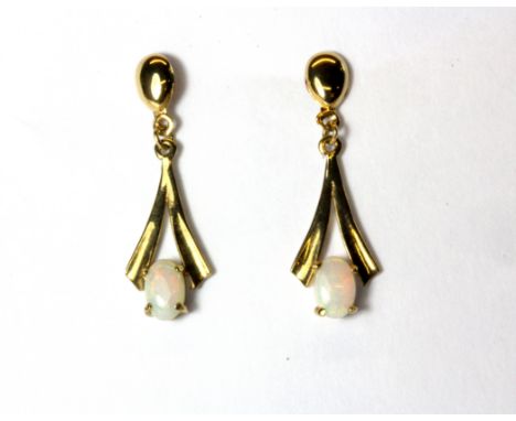 A pair of yellow metal (tested minimum 9ct gold) opal set drop earrings.