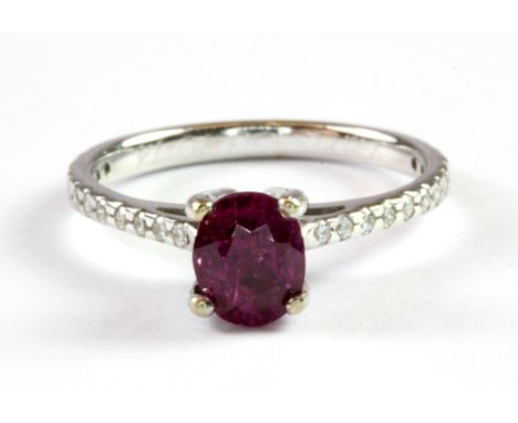 A white metal (tested 18ct gold) ring set with a cushion cut 1.60ct natural Vietnamese ruby and diamond set shoulders, with a