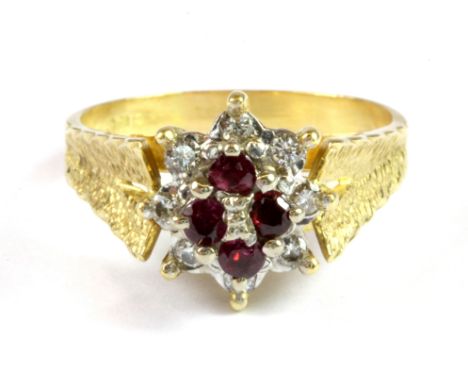 An 18ct yellow and white gold ruby an diamond set cluster ring, (S).