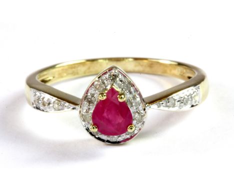 A 9ct yellow gold ring set with a pear cut ruby and diamond set ring, (L.5).