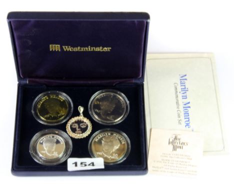 A boxed Marilyn Monroe commemorative coin set including two .999 silver coins and a further silver pendant.