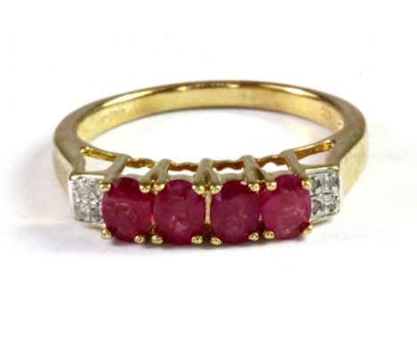 A 9ct yellow gold ruby and diamond set ring, (L.5).