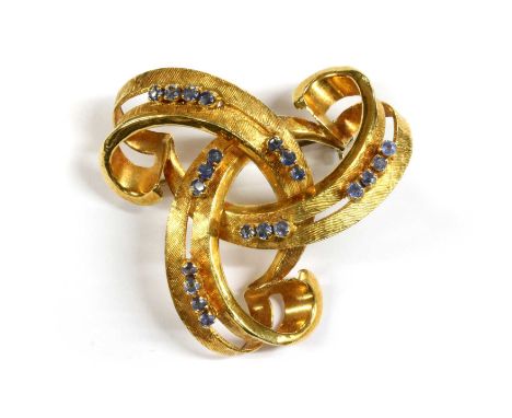 An Italian gold sapphire set brooch, of openwork knot form claw set with rows of three and four circular mixed cut sapphires,