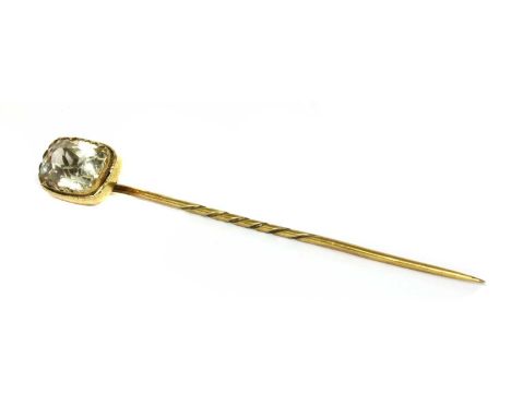 A yellow metal topaz stick pin, a cushion cut pale yellow topaz, rub set in yellow metal with an applied gold outer collar, t