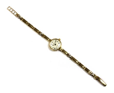 A ladies' 9ct gold quartz bracelet watch, 17.5mm diameter with a silvered dial signed J Hatton, black Roman numerals and spad