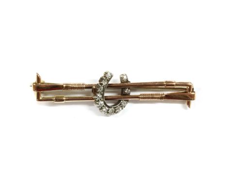 A gold and silver diamond set horseshoe bar brooch, a horseshoe shaped centrepiece with a slightly graduated row of old eight