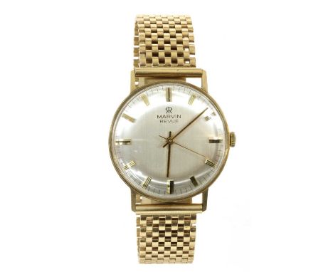 A 9ct gold Marvin Revue mechanical bracelet watch, 33mm diameter with a silvered dial, raised gilt baton hour markers and cen