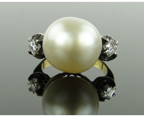 A large pearl set ring,
with princess-cut diamond set shoulders, unmarked gold settings, pearl 13mm across, size H.