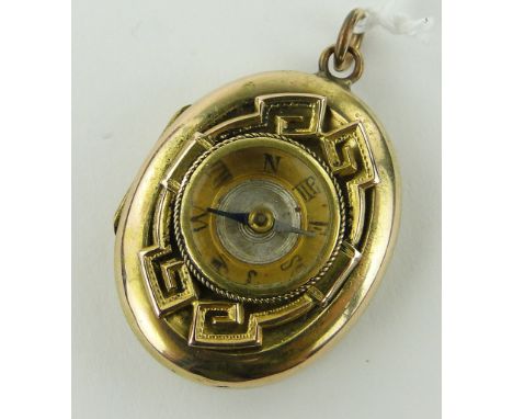 A Victorian unmarked gold locket,
with inset compass to the lid, height 30mm.
