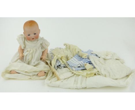 An Armand Marseille baby doll
with bisque porcelain head, jointed composition limbs, height 16".