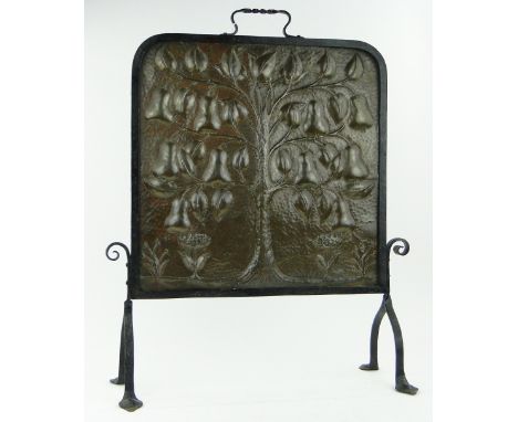 A fine Arts and Crafts embossed copper firescreen by John Pearson,
with pear tree design, in wrought iron frame, signed and d