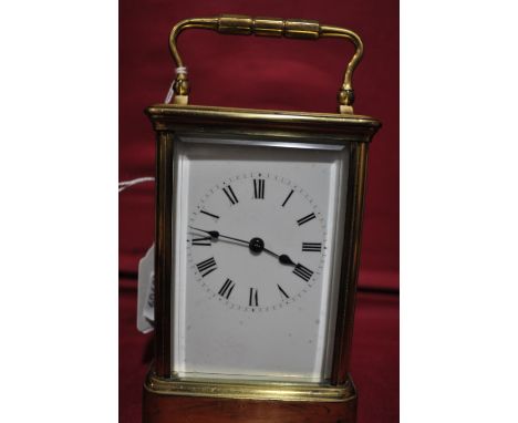 A French brass cased carriage clock,
with engraved dedication dated 1879, height 5".
