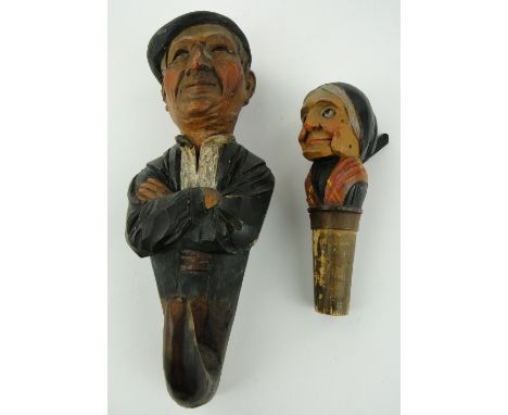 A carved and painted wood coat hook
in the form of a French man, height 7.5" and a carved wood automaton bottle stopper (2)