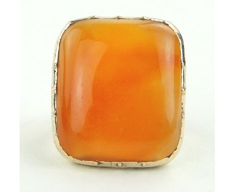 A 19th century Cornelian set ring in engraved unmarked gold setting,
setting height 22mm, size M.