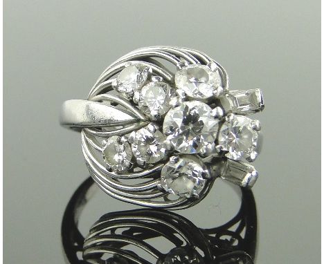 A platinum and diamond cocktail ring circa 1940/50s,
set with 10 baguette and old-cut diamonds, largest 5mm across, size N.