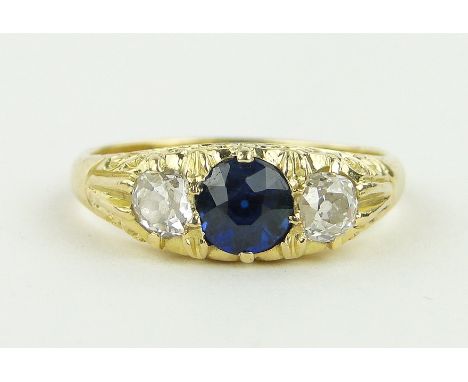 A 3 stone sapphire and diamond ring in carved settings,
unmarked gold settings, size Q.