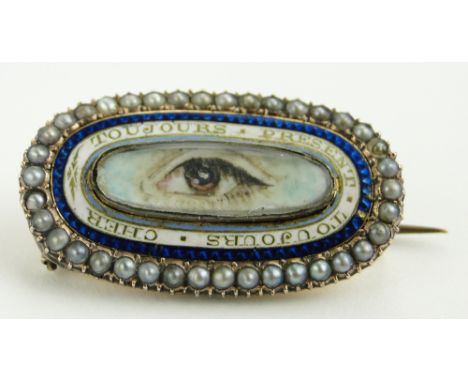 A 19th century French memorial brooch
with central hand painted eye in enamel surround with French inscription in a seed pear
