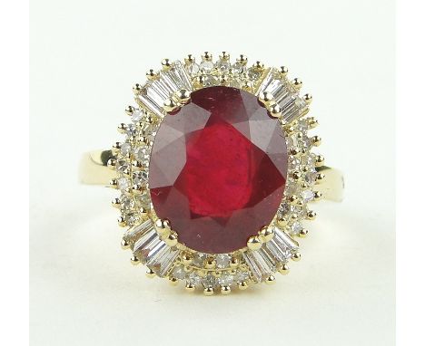 A 14ct gold ruby (5.4cts) and diamond (1.1ct total) cluster ring,
setting height 11mm, size M.