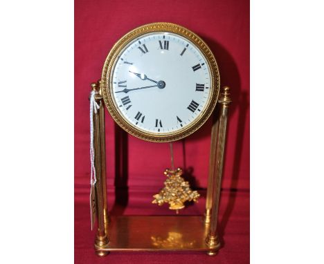 A brass 4 pillar pendulum clock with enamel dial,
height 8.5".
