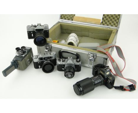 A Canon T70 camera
with FD70-200mm lens, 4 other cameras and lenses, in metal case.