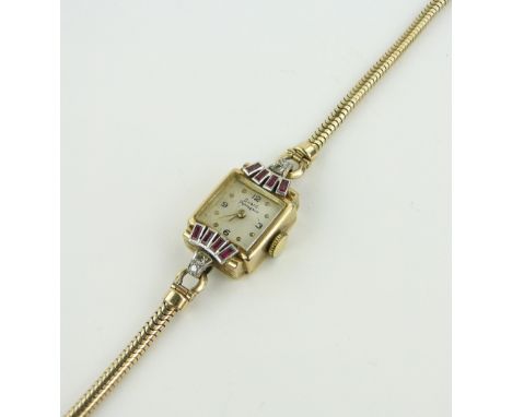 A lady's Girard perregaux 9ct gold ruby and diamond cocktail wristwatch,
with 9ct articulated strap, case width 13mm, gross w