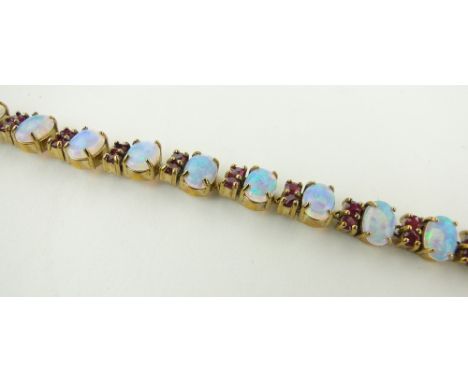 A 9ct gold opal and red stone set bracelet, a/f.