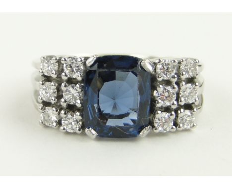 A 14ct white gold sapphire and diamond dress ring,
diamond content approx. 0.35cts, size N.