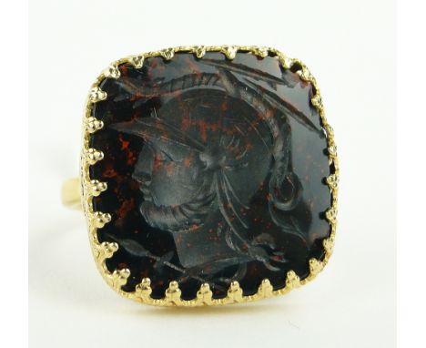 A carved bloodstone seal ring,
unmarked gilt metal settings, setting height 18mm.