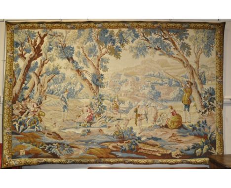 A large machine made tapestry depicting a country hunting scene,
9' x 6'.