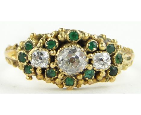 A Victorian unmarked gold emerald and diamond set ring,
setting width 15mm, size L.