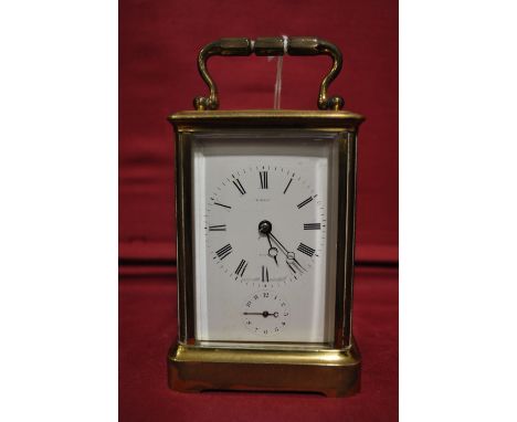 A French brass cased carriage clock with alarm and white dial,
height 4.75".
