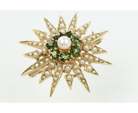 9ct gold hallmarked green stone and star brooch. The brooch set with a round pearl to the centre surrounded by seven round cu