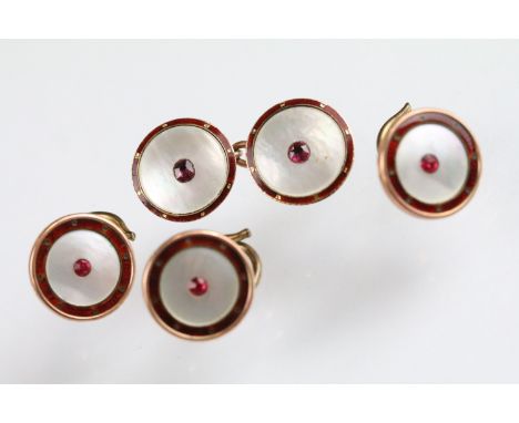 Three early 20th Century 9ct gold and mother of pearl dress buttons and one cufflink having red enamelled borders with red st